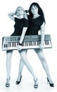 Blonde and brunette with electric piano Royalty Free Stock Photo