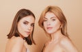 Blonde and brunette sexy girls. Natural beauty portrait. Young girls with clear skin and perfect nude makeup. Natural Royalty Free Stock Photo