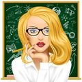 Blonde business woman in glasses near the blackboard Royalty Free Stock Photo