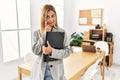 Blonde business woman at the office pointing to the eye watching you gesture, suspicious expression Royalty Free Stock Photo