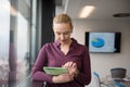 Blonde businesswoman working on tablet at office Royalty Free Stock Photo