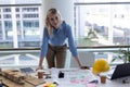 Blonde Caucasian female architect looking at camera at desk in office Royalty Free Stock Photo