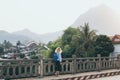 Blonde Caucasian woman walking on the bridge at sunset in Nong Khiaw, Laos Royalty Free Stock Photo