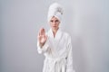 Blonde caucasian woman wearing bathrobe doing stop sing with palm of the hand Royalty Free Stock Photo