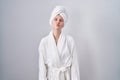 Blonde caucasian woman wearing bathrobe looking at the camera blowing a kiss on air being lovely and sexy Royalty Free Stock Photo