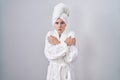 Blonde caucasian woman wearing bathrobe shaking and freezing for winter cold with sad and shock expression on face Royalty Free Stock Photo