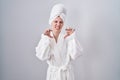 Blonde caucasian woman wearing bathrobe smiling funny doing claw gesture as cat, aggressive and sexy expression Royalty Free Stock Photo