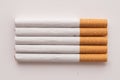 blonde cigarettes with filter on a white table, white background Royalty Free Stock Photo