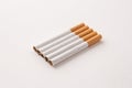 blonde cigarettes with filter on a white table, white background Royalty Free Stock Photo