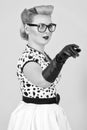 Blonde curl woman pointing away with her hand isolated in studio