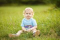 Blonde curly baby boy playing in the summer park Royalty Free Stock Photo