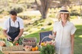 Blonde customer holding a vegetables basket Royalty Free Stock Photo