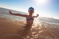 Blonde cute seven-year-old girl having fun and having a good time at the sea during the holidays Royalty Free Stock Photo