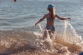 Blonde cute seven-year-old girl having fun and having a good time at the sea during the holidays Royalty Free Stock Photo