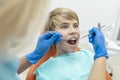 Blonde Dentist Examines the Boy`s Teeth