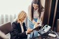 Blonde executive businesswoman doing multitasking work in office. Royalty Free Stock Photo