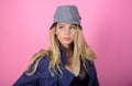 Blonde fashion model on pink background. Woman mysterious face wear hat. Confident and fashionable. Modern style. Girl
