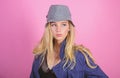 Blonde fashion model on pink background. Woman mysterious face wear hat. Confident and fashionable. Modern style. Girl