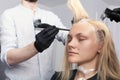 A blonde female client coloring hair in hairdressing salon Royalty Free Stock Photo