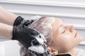 A blonde female client coloring hair in hairdressing salon Royalty Free Stock Photo