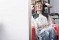 A blonde female client coloring hair in hairdressing salon Royalty Free Stock Photo