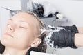 A blonde female client coloring hair in hairdressing salon Royalty Free Stock Photo