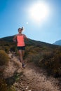 Blonde female trail runner running through a mountain landscape Royalty Free Stock Photo