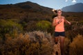 Blonde female trail runner running through a mountain landscape Royalty Free Stock Photo