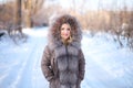 Blonde in the fur-collared jacket pulled on the hood Royalty Free Stock Photo