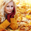 Blonde girl in Autumn Park with Maple leaves. Fashion Royalty Free Stock Photo