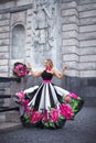 A blonde girl in a couture fashion dress with pink peonies and black and white stripes Royalty Free Stock Photo