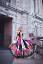 A blonde girl in a couture fashion dress with pink peonies and black and white stripes Royalty Free Stock Photo