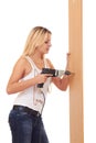 Blonde girl drilling the wall