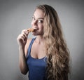 Blonde girl eating a biscuit Royalty Free Stock Photo