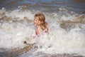 Blonde girl enjoying the waves