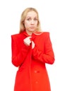 Blonde girl with an expression of amazement on her face in red clothes on a white background