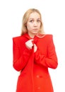 Blonde girl with an expression of amazement on her face in red clothes on a white background