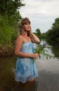 Blonde girl in flower chaplet at river Royalty Free Stock Photo