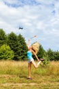 The blonde girl with a fly swatter drives away drone Royalty Free Stock Photo