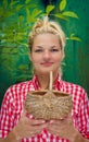 Blonde girl on a green background holding basket