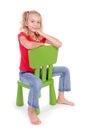 Blonde girl on green chair Royalty Free Stock Photo