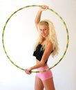 Blonde girl with hula hoops isolated on a white background Royalty Free Stock Photo