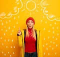 Girl indicates the sun between the clouds above. Amazed and shocked expression. Yellow background