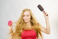 Blonde girl long blowing hair holds two brushes Royalty Free Stock Photo