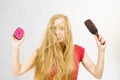 Blonde girl long blowing hair holds two brushes Royalty Free Stock Photo