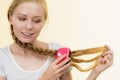 Blonde girl with long braid hair holds brush Royalty Free Stock Photo