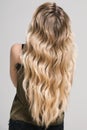 Blonde girl with long and volume shiny wavy hair. Royalty Free Stock Photo