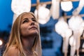 Blonde girl looking at the sky decorated with unfocused Chinese lanterns in the background Royalty Free Stock Photo