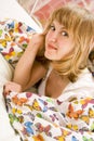 Blonde girl lying under a blanket with butterflies