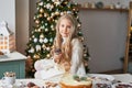 Blonde girl in the New Year`s kitchen